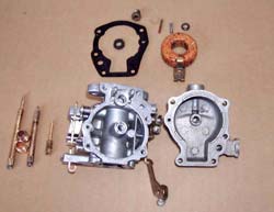 CARBURETOR DISASSEMBLED, OLD PARTS IN REAR.